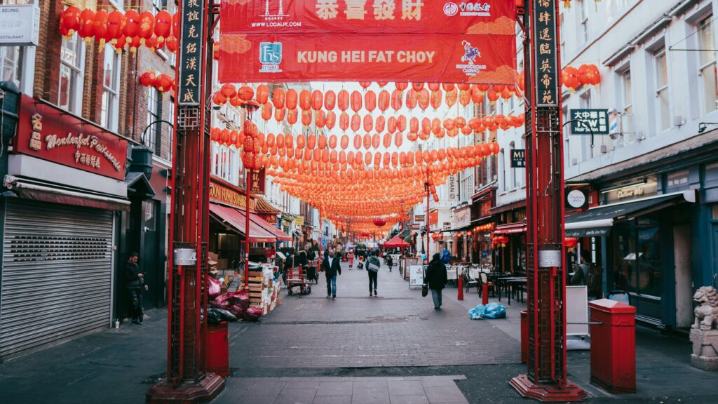 Vibrant street in London's Chinatown adorned with red lanterns, capturing cultural essence.